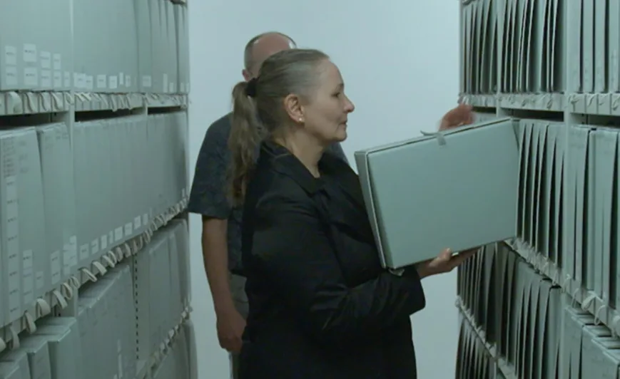 Filmstill aus Nebelkinder. Zwei Personen im Archiv